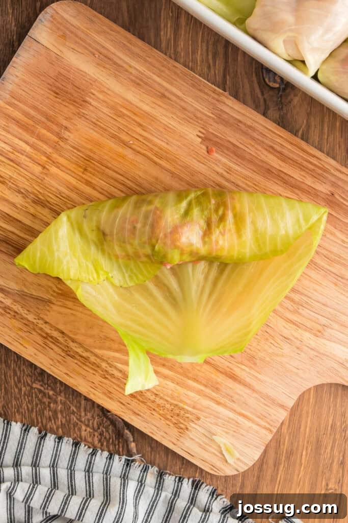 Cabbage leaf partially folded over the filling to start forming a cabbage roll.