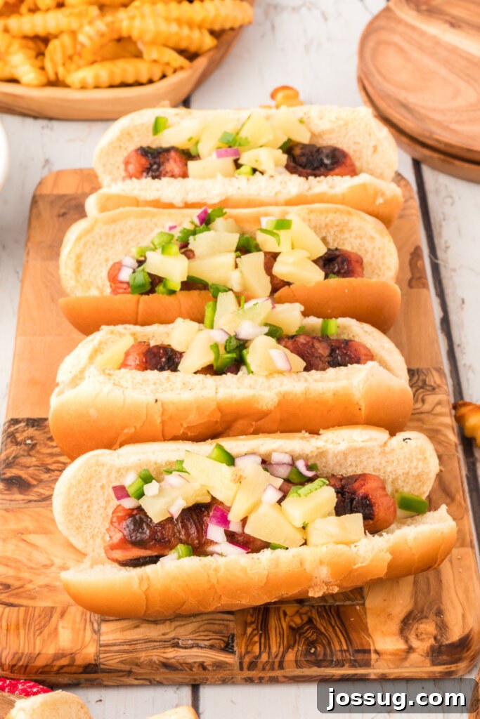 Close-up of hot dogs arranged on a cutting board before wrapping