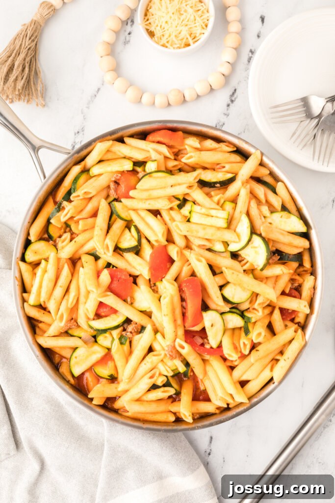 Savory Pork and Zucchini Skillet Meal 2 Pork Zucchini Skillet Dinner, bubbling gently in a large pan, garnished with fresh herbs