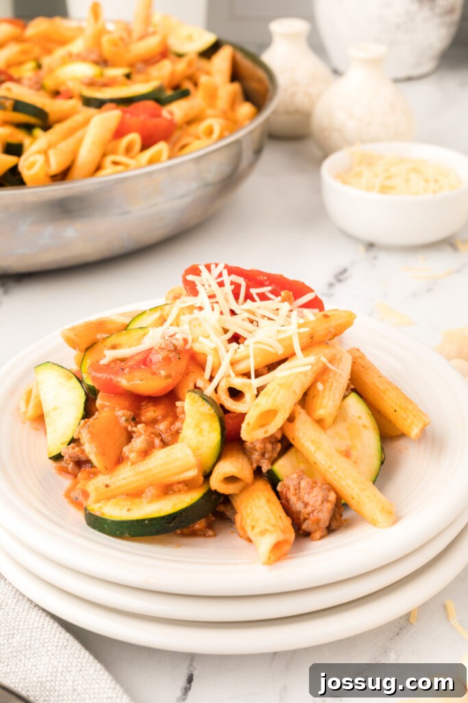 Savory Pork and Zucchini Skillet Meal 4 A portion of pork zucchini skillet dinner served on a white plate with a fork