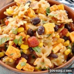 A colorful bowl of Taco Pasta Salad, ready to be served at a party.