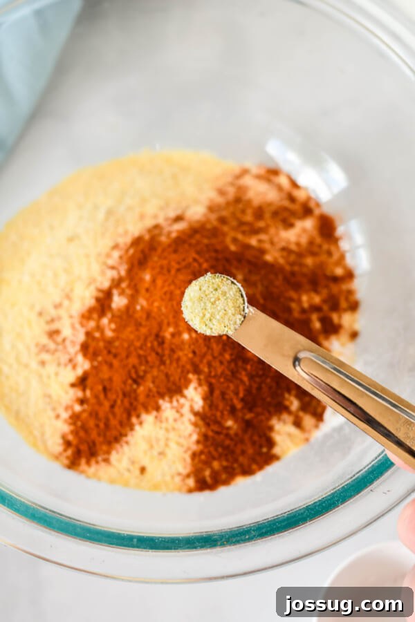 adding garlic powder to cornmeal mixture