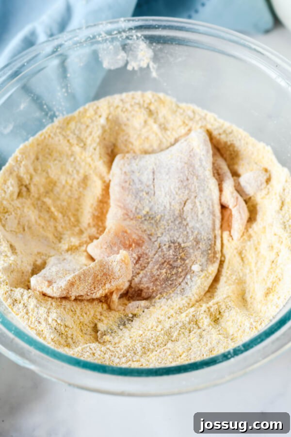 coating the fish fillet in cornmeal mixture
