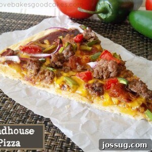 A vibrant slice of Roadhouse Pizza, featuring a rich BBQ sauce base, seasoned ground beef, crispy bacon, sliced jalapenos, fresh tomatoes, and red onion, all crowned with melted cheddar cheese.