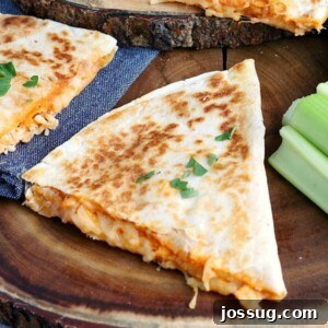 Crispy Buffalo Chicken Quesadillas 2 Two perfectly cooked Buffalo Chicken Quesadillas cut into wedges, served with a side of blue cheese dressing and crisp celery sticks.