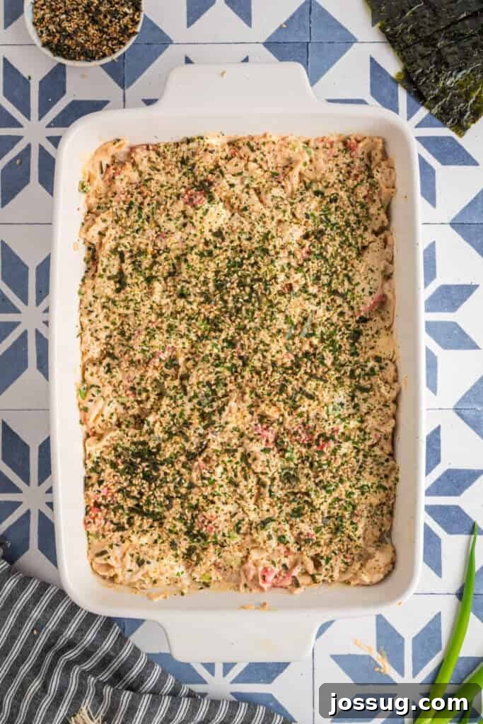 Homemade Sushi Bake Delight 9 Sushi bake topped generously with furikake seasoning, adding color and texture before baking.