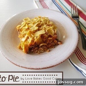 A delicious Frito Pie casserole, fresh out of the oven, topped with melted cheese and ready to serve.