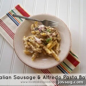Italian Sausage and Creamy Alfredo Pasta Bake 2 A close-up shot of the finished Italian Sausage & Alfredo Pasta Bake, showing melted cheese and visible chunks of sausage, pasta, and vegetables.