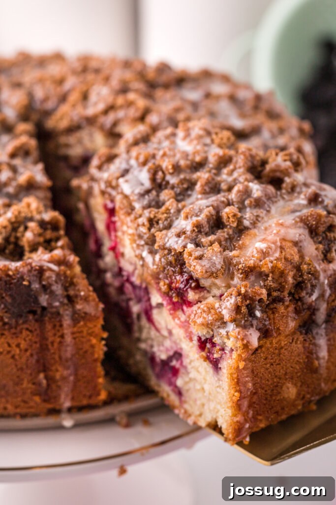 A serving of blackberry lemon coffee cake being removed from the pan