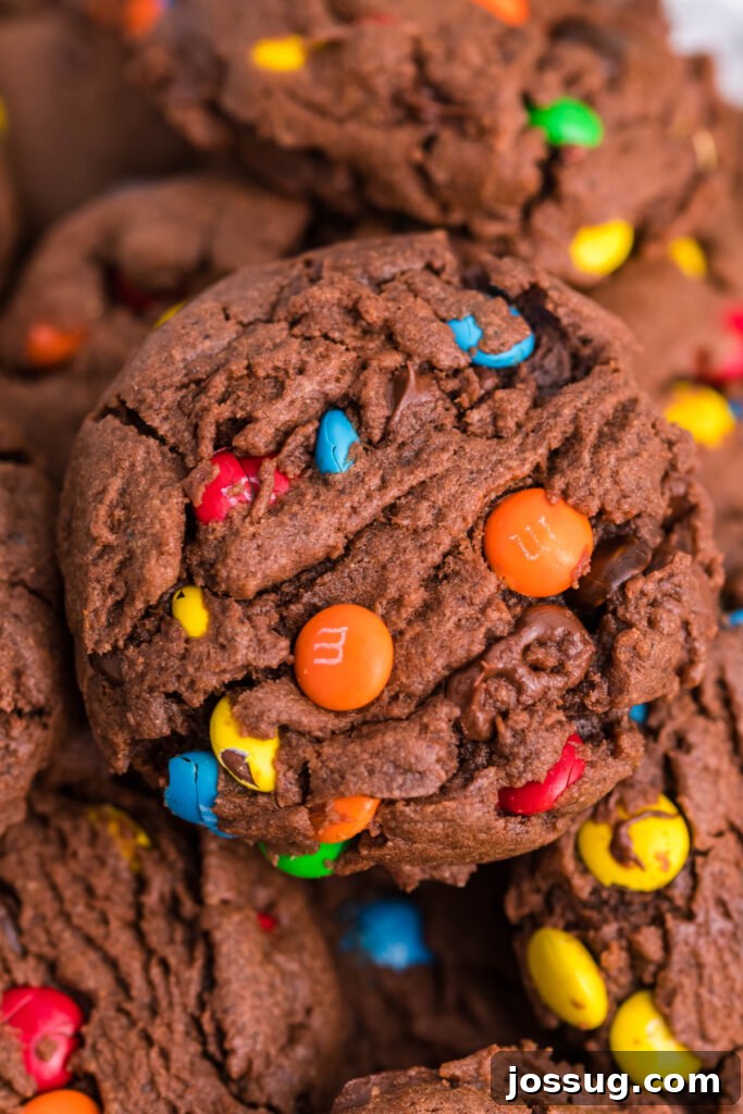 Close-up of freshly baked M&M cookies showcasing their soft texture and vibrant candy pieces embedded within the chocolate dough.
