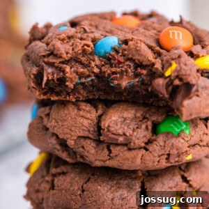 A delicious M&M cookie with a bite taken out, showing its soft interior and colorful candies.