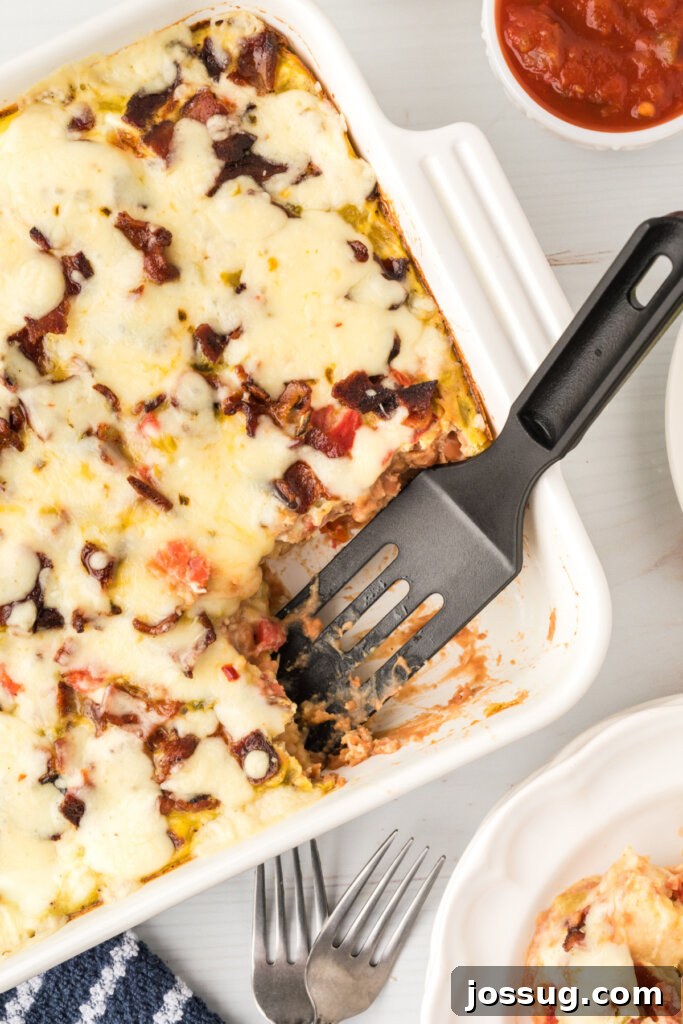 Hearty Fiesta Breakfast Bake 2 mexican breakfast casserole in pan with scoop taken out