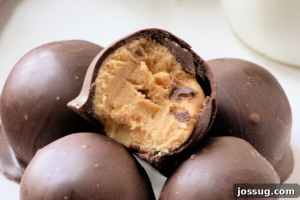 Decadent Peanut Butter Truffles 9 A close-up of a peanut butter ball with a bite taken out, revealing the soft, creamy center