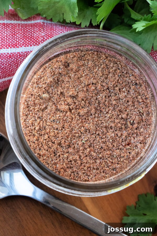DIY Taco Spice Mix 2 Closeup looking down into a jar of homemade taco seasoning, showcasing its rich colors and texture