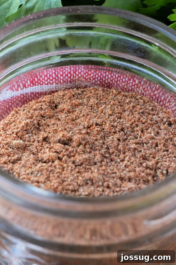 DIY Taco Spice Mix 7 A close-up view of the mixed taco spices inside a glass jar, showing texture and rich color