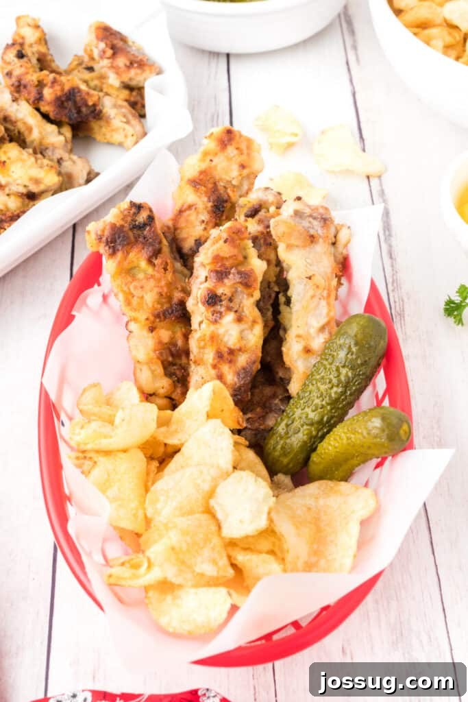 Crispy Steak Strips 12 red food basket with steak fingers, potato chips, and pickles