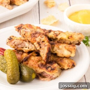 steak fingers on plate with pickles
