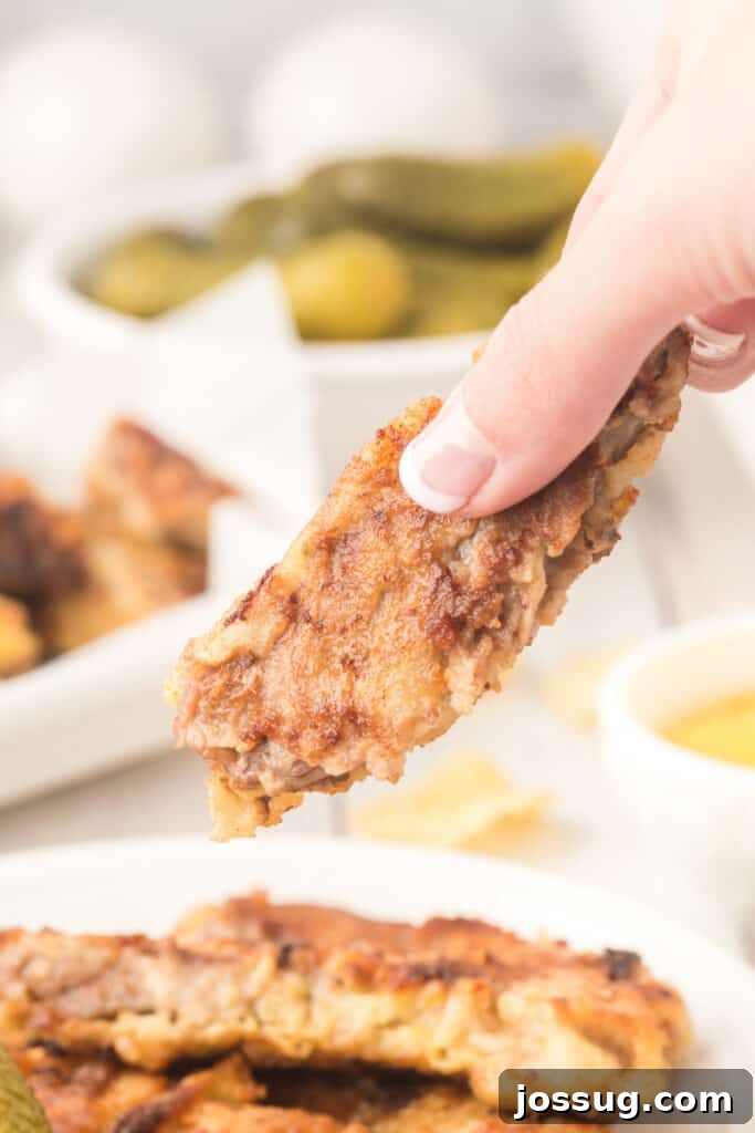 Crispy Steak Strips 4 hand holding a steak finger