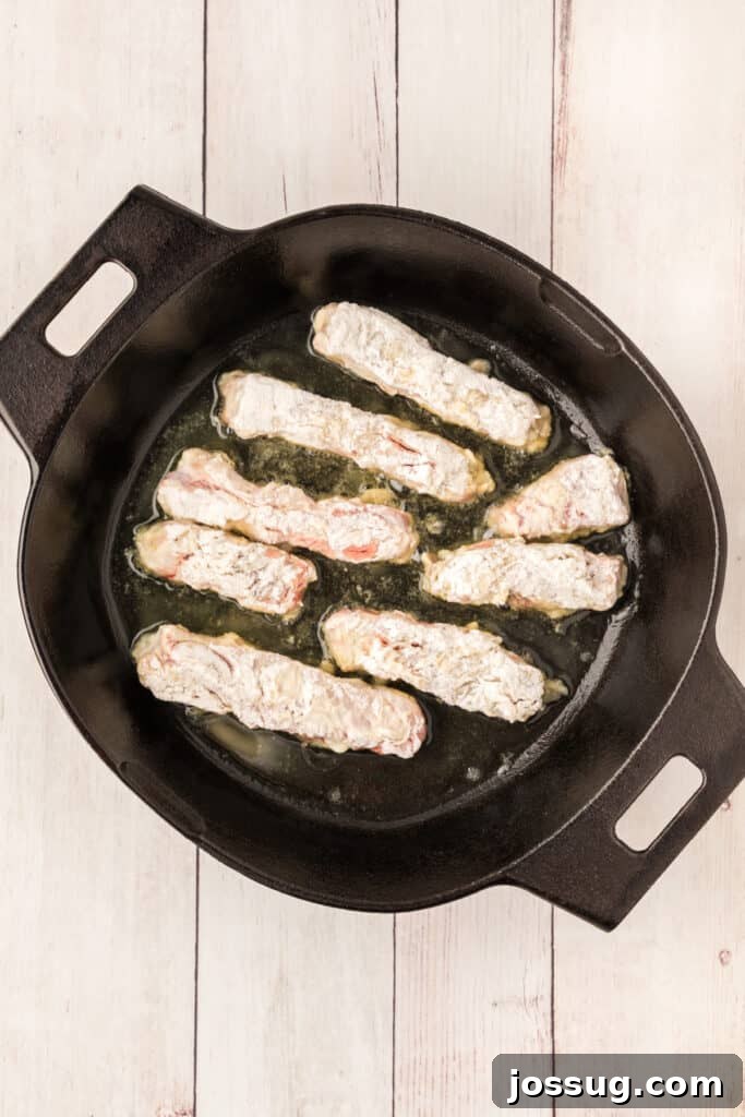 Crispy Steak Strips 9 Heat 2 tablespoons of the oil in a skillet over medium heat. Add half of the strips and brown on both sides.