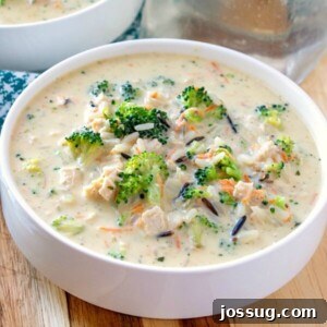 chicken broccoli and rice soup brimming in a creamy broth in bowl