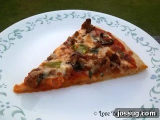 Homemade Supreme Pizza ready to be enjoyed, garnished with fresh herbs.