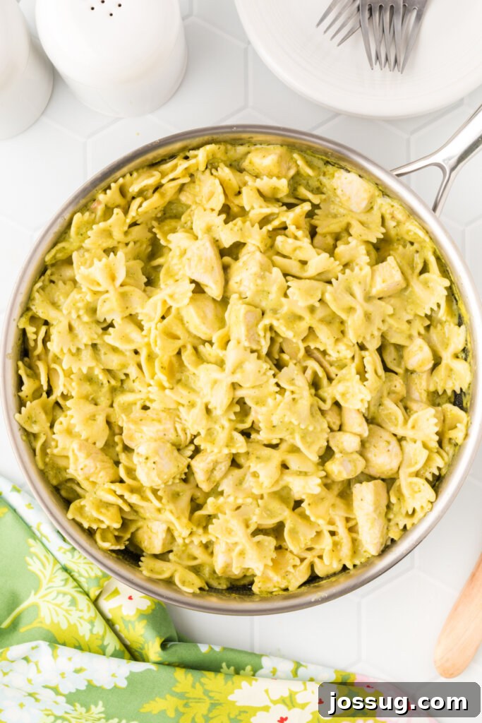 creamy chicken pesto pasta in a skillet