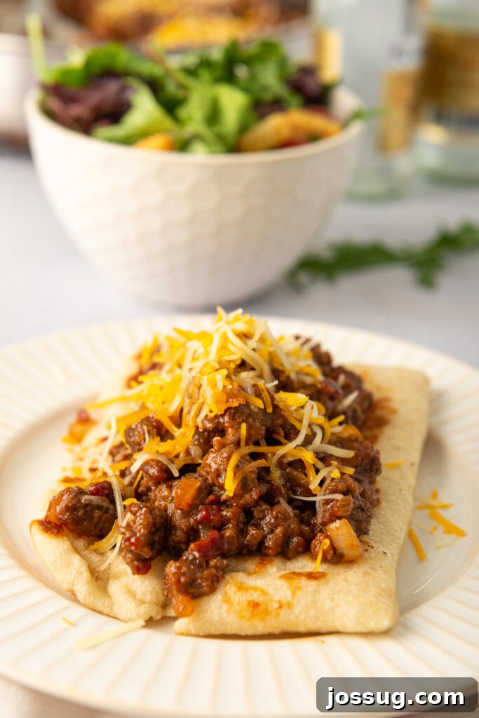 Delicious BBQ Bacon Cheeseburger Flatbread Melts served on a plate, ready to eat.