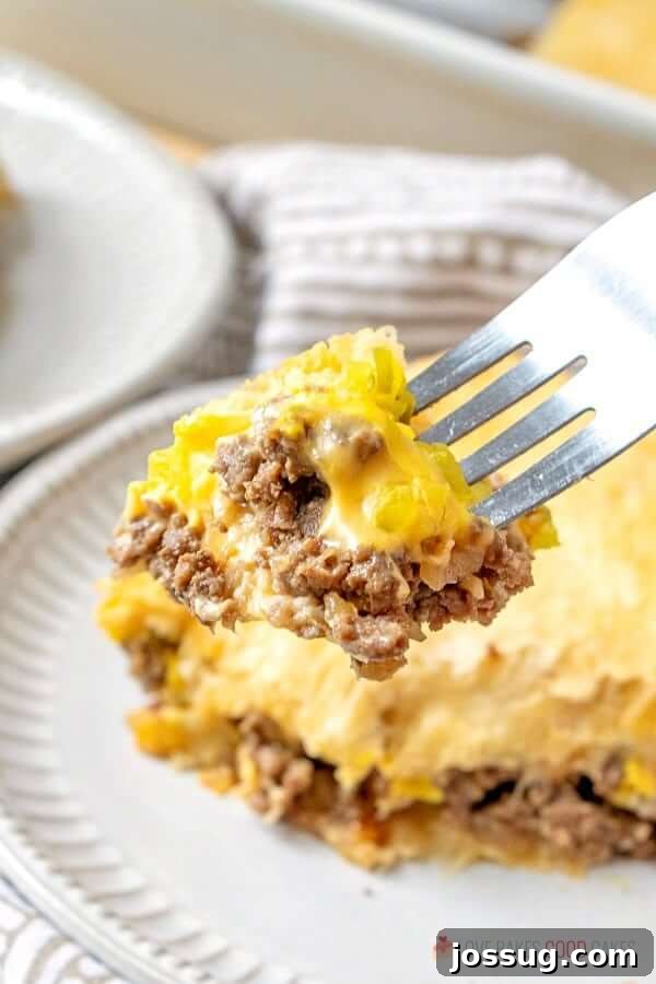 A close-up shot of a fork lifting a bite-sized piece of White Castle Casserole, showing the layers.