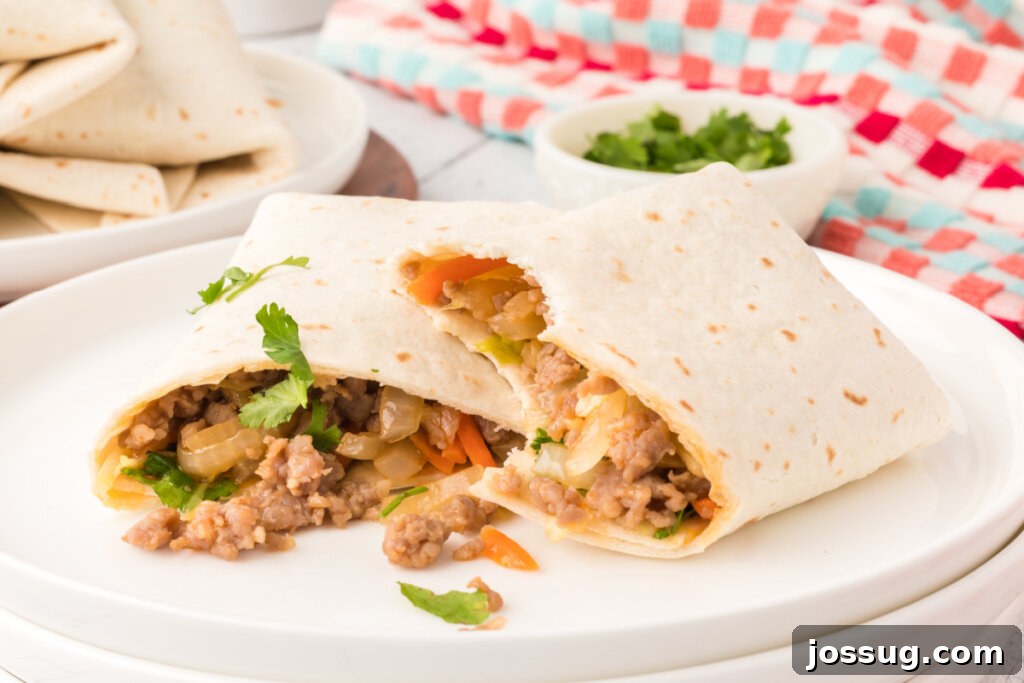 Four perfectly rolled Thai Pork Burritos, garnished with fresh cilantro, arranged enticingly on a white plate, ready to be enjoyed.