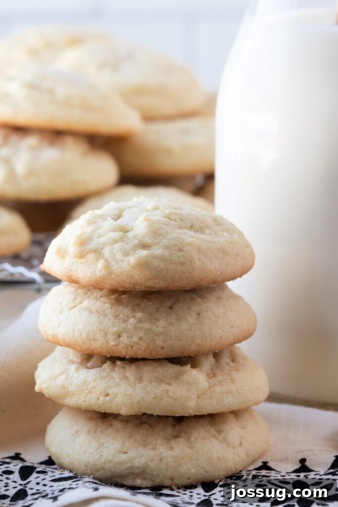 Southern Comfort Tea Cakes 4 Four golden-brown Southern tea cakes stacked next to a charming glass milk bottle.