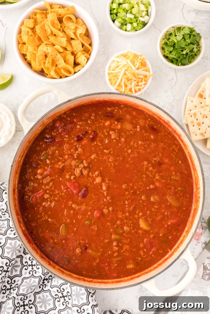 A large pot filled with rich, bubbling Wendy's Copycat Chili, simmering gently on the stovetop, releasing its aromatic steam.