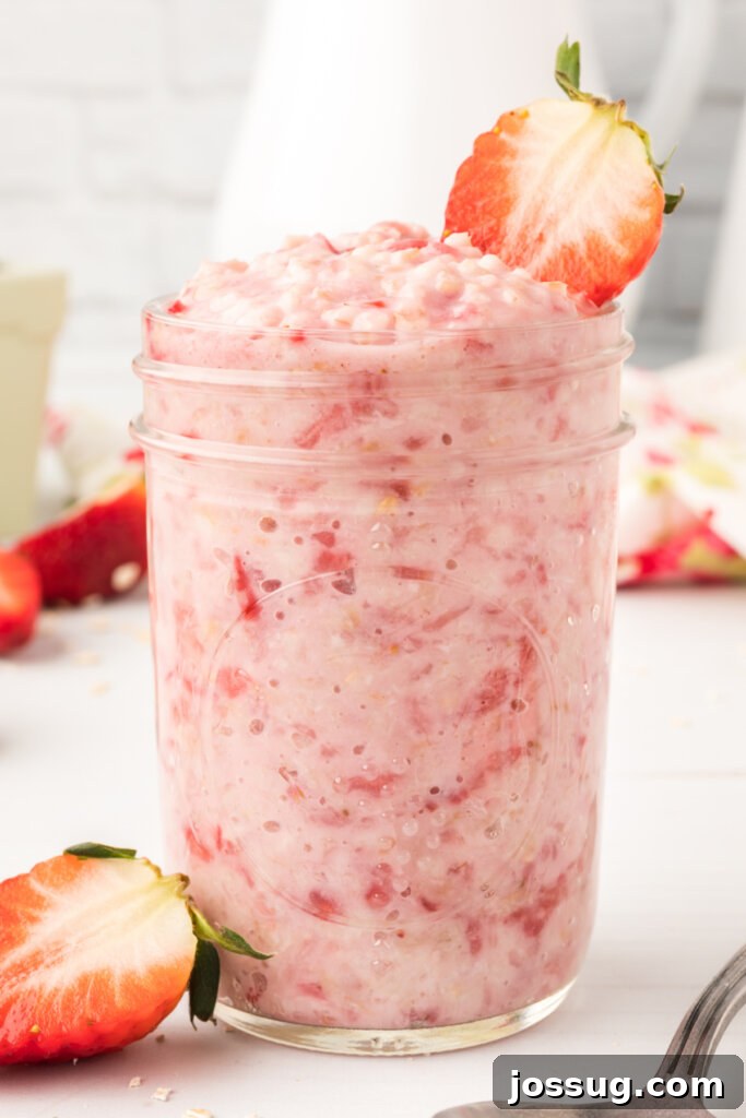Strawberry Cloud Oatmeal 4 Strawberries and cream oatmeal presented beautifully in a glass mason jar, perfect for on-the-go breakfasts.