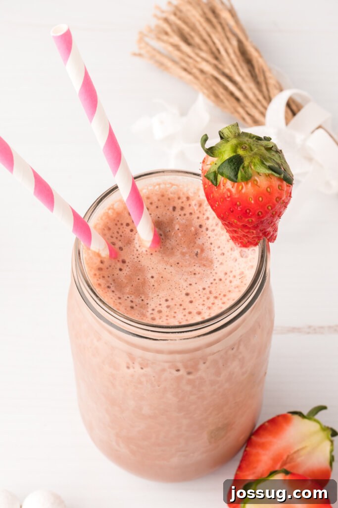 A vibrant Chocolate Covered Strawberry Smoothie in a mason jar, perfect for a healthy breakfast or snack.