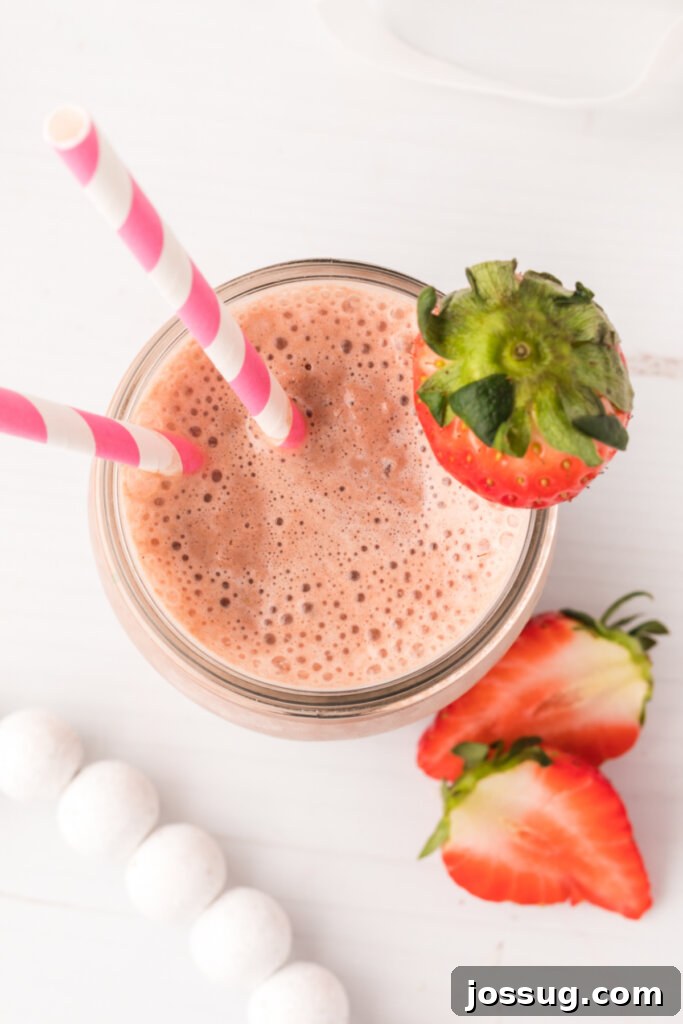 Looking down into a beautifully blended chocolate and strawberry smoothie, showcasing its appetizing texture.