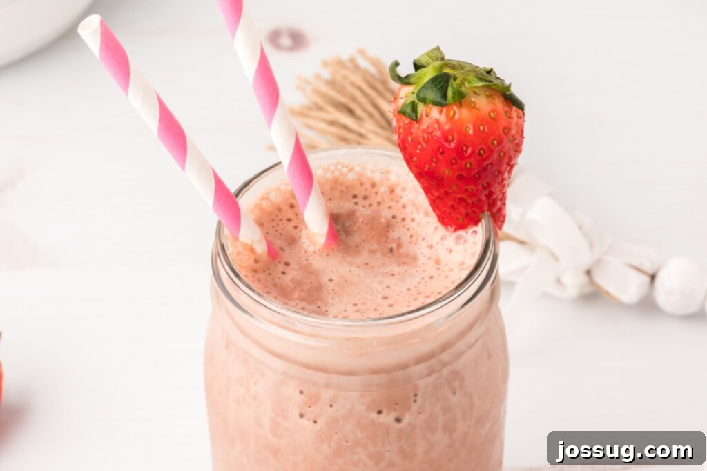 A close-up of a perfectly blended chocolate strawberry smoothie, ready to be enjoyed as a refreshing drink.