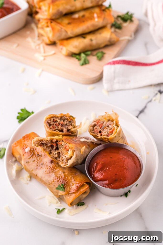 Plate of homemade pizza rolls served with a side of marinara or pizza sauce for dipping