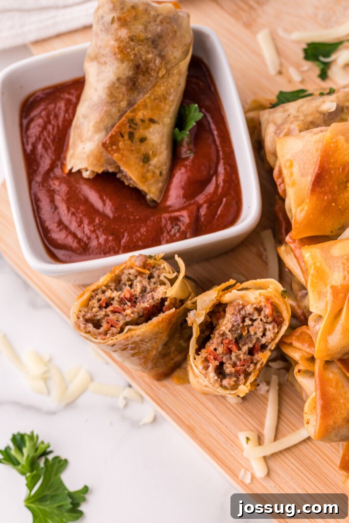 Single homemade pizza roll dipped in rich red pizza sauce