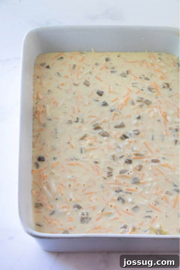 The egg and cheese mixture smoothly poured into a baking dish, ready to be transferred to the oven.