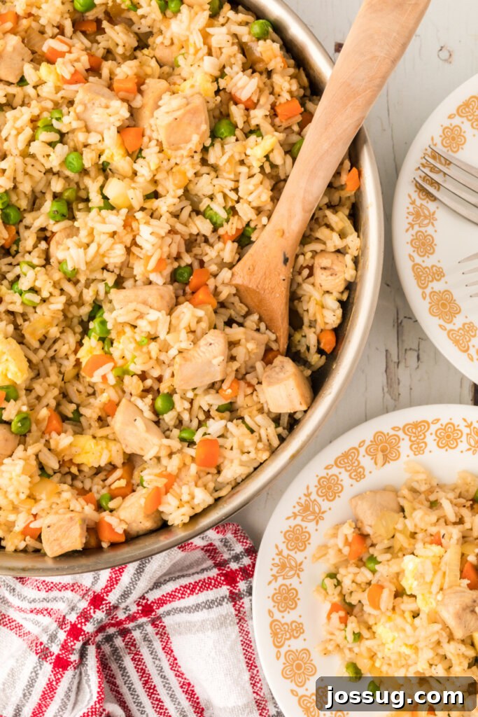 Plate and skillet filled with delicious homemade chicken fried rice