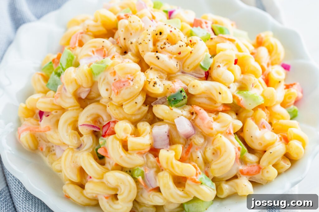 A close-up shot of cooked elbow macaroni, showcasing its readiness to be mixed into a salad.