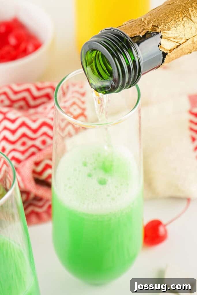 Champagne being poured into the Grinch Mimosa
