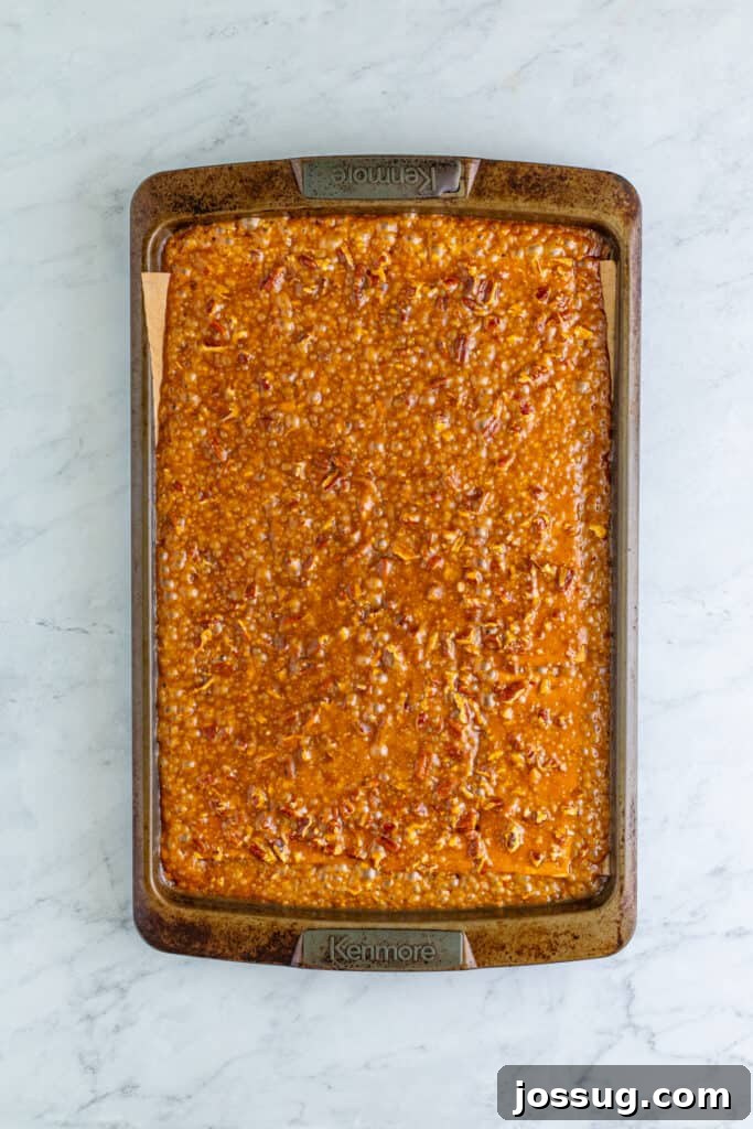 Toffee Graham Bliss Bites 7 Baked caramel and pecan-covered graham crackers fresh from the oven on a baking sheet