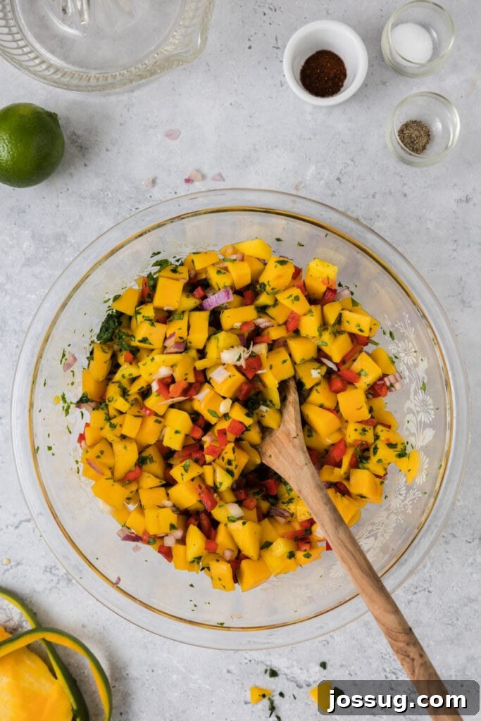 Mango Salsa Delight 7 Mixing mango salsa with a wooden spoon