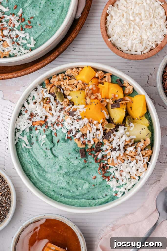 Tropical Blue Spirulina Smoothie Bowl 2 Tropical Blue Spirulina Smoothie Bowl Topped with Pineapple, Coconut, Seeds, and Granola