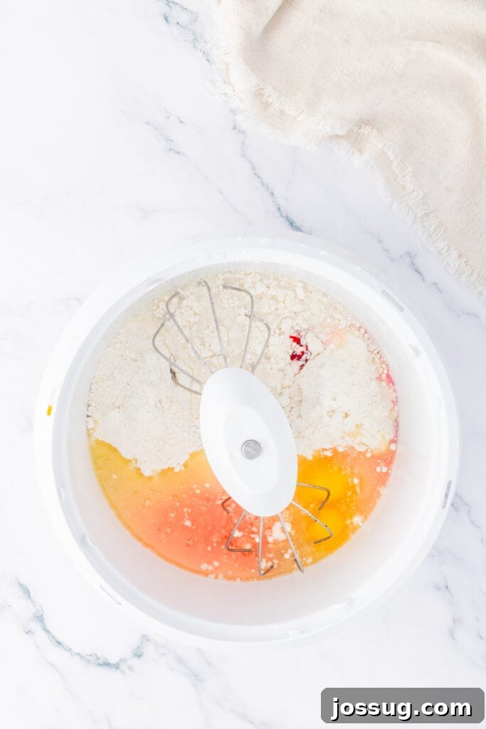Cake batter ingredients in a mixing bowl before being combined