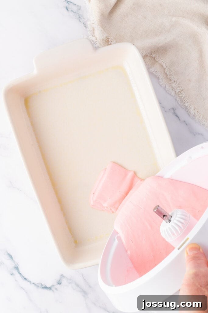 pouring cake batter mixture into a rectangle baking dish
