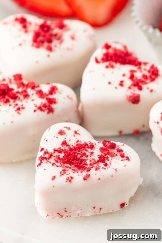 Strawberry Cream Truffle Hearts 2 Heart-shaped strawberries and cream truffle hearts coated in white candy with crushed freeze-dried strawberries on top
