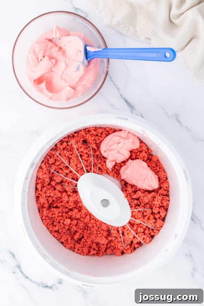 Strawberry Cream Truffle Hearts 7 Pink cream cheese frosting added to strawberry cake crumbs in a mixing bowl