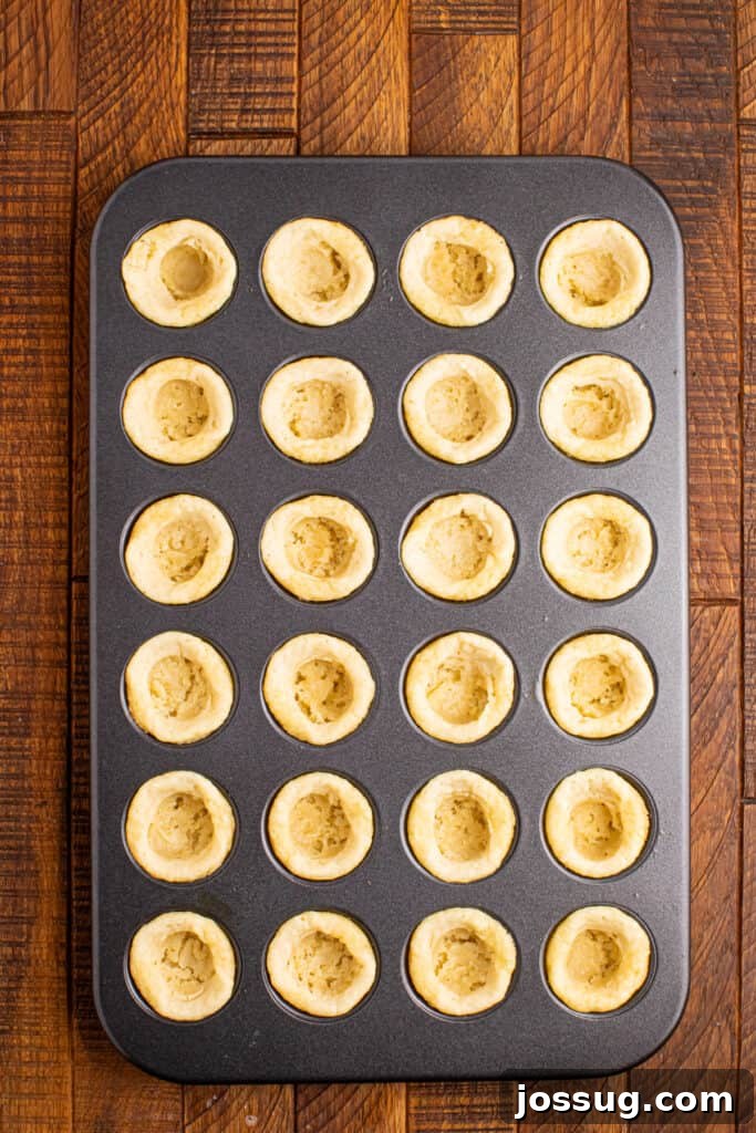 Valentine's Day Sugar Cookie Cups 4 Baked sugar cookie cups pressed in a mini muffin pan showing the hollow centers
