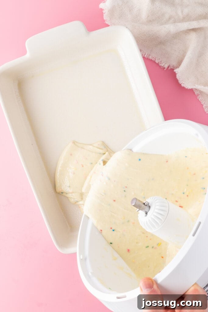 Birthday Cake Bites 4 Baked funfetti cake being removed from a pan after cooling